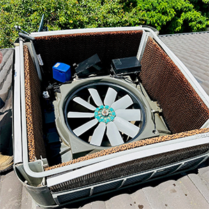evaporative cooler with top open showing fan and internal parts